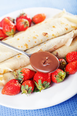 Pancakes with chocolate and strawberries