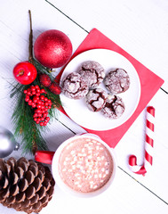 Hot chocolate and fresh cookies with Christmas ornaments on whit
