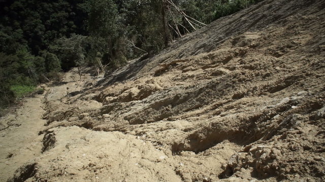 Tilt up shot of a large clay based soil landslide or mudslide in the Andes mountains of Ecuador.