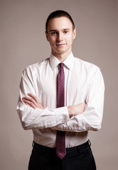 Portrait of young happy smiling business man, isolated over white background
