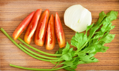 Tomato , celery, onion on the wooden floor