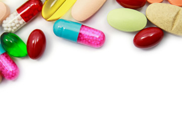 Many colorful pills on white background