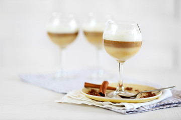 Wine glass with jelly on table, on light background