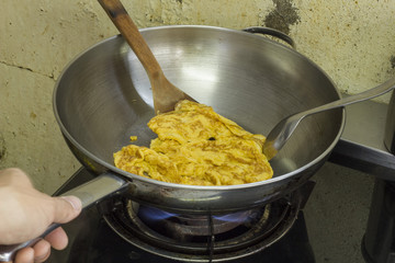 The fried egg Cooking in a pan at a kitchen
 Smell good and easy to do - thailand food