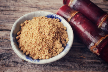 Brown sugar with sugar cane
