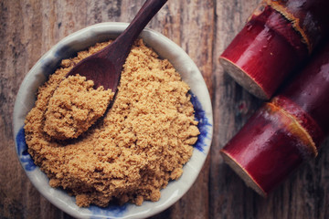 Brown sugar with sugar cane