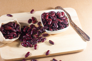 red bean in sack on wood background with wood ladle