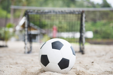 Fototapeta na wymiar football in front of the mini goal on the sand