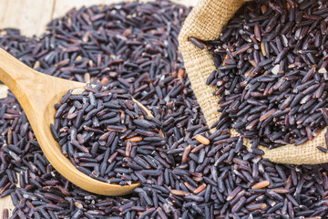 Rice berry in a wooden spoon.