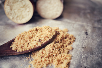 Brown sugar with sugar cane