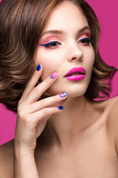 Beautiful model girl with bright pink makeup and colored  nail polish. Beauty face. Short colorful nails