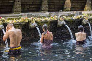 Travellers praying and take a bath at holy spring water.