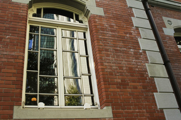 Scenery reflected in the windows on the building's brick