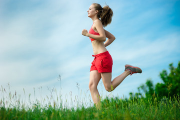 Young woman running summer park rural road. Outdoor exercises. J