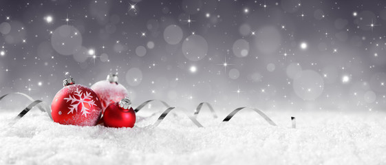 Red Baubles On Snow With Sparkling Stars On Silver Background
