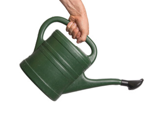 Hand holding green watering can