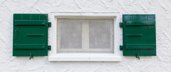 Fototapeta na wymiar Open wooden green shutters
