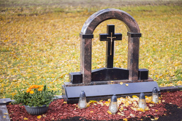 Black marble cross with a crucified Christ sculpture
