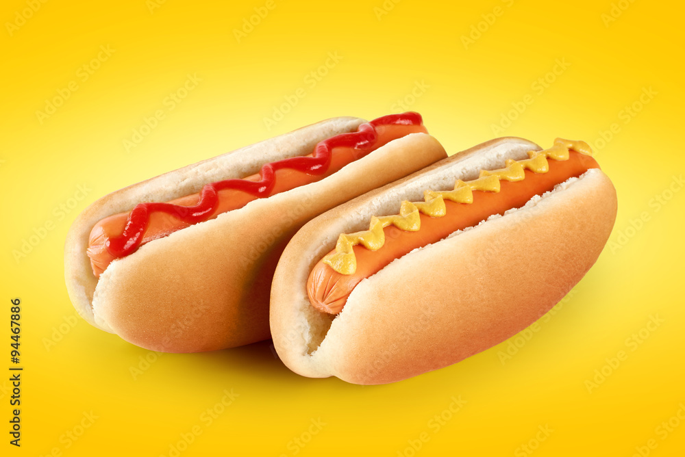 Wall mural Hot dogs with ketchup and mustard on a yellow background.