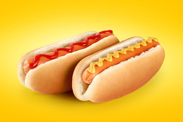 Hot dogs with ketchup and mustard on a yellow background.