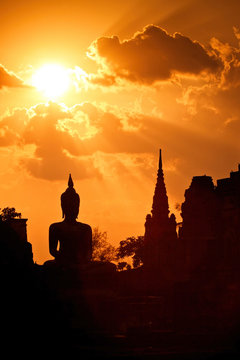 Silhouette of Buddha in a temple at Thailand evening.