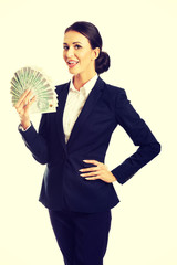 Businesswoman holding a clip of polish money
