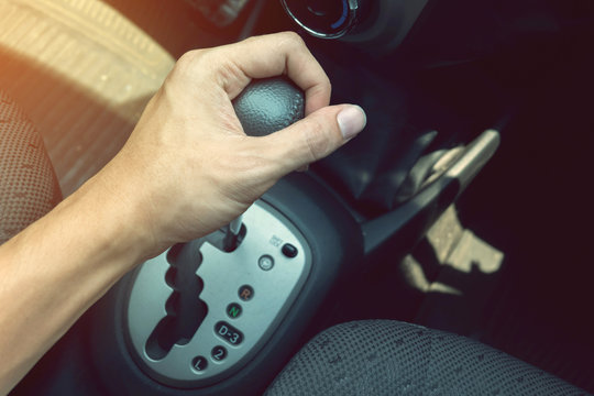 driver man hand holding automatic transmission in car
