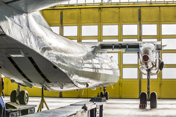 Аirplane on service in hangar without wing