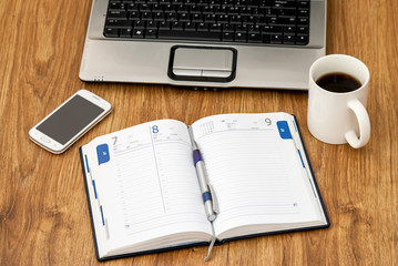 office table with notebook, cup of coffee, notebook and smartphone. copy space