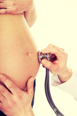 Fototapeta premium Pregnant woman being examine by doctor