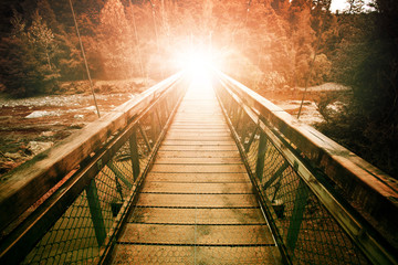 warp light at the end of suspension bridge crossing steam in wil