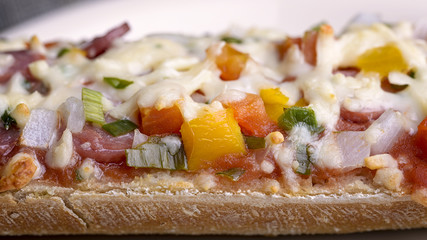 baked baguette with salami, cheese and vegetable
