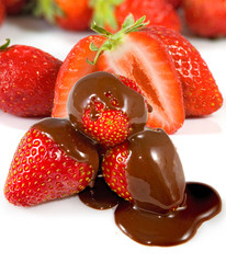 Isolated image of ripe strawberries in chocolate on a white background closeup