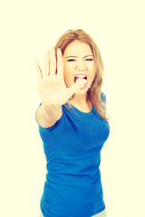 Young woman making stop sign.