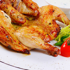 The baked hen with salad close-up