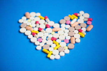 Pills in a heart shape close-up.