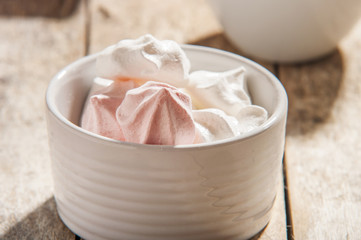 French meringue cookies on wooden background