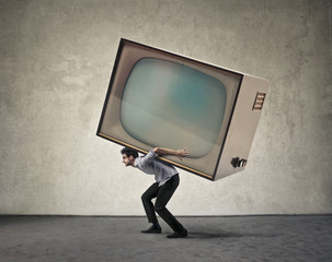 Man carrying a giant tv - obrazy, fototapety, plakaty