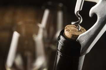 Opening wine bottle with a corkscrew