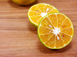 Fototapeta na wymiar fresh orange juice on wooden table over grunge background