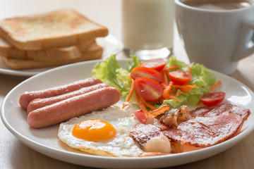 English breakfast with coffee and milk on wood table. Selective
