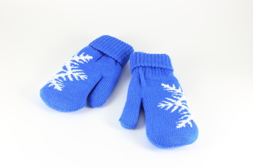 Pair of knitted mittens with pattern snowflake, isolate on white