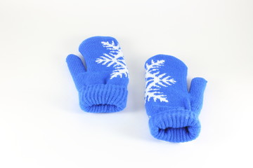 Pair of knitted mittens with pattern snowflake, isolate on white