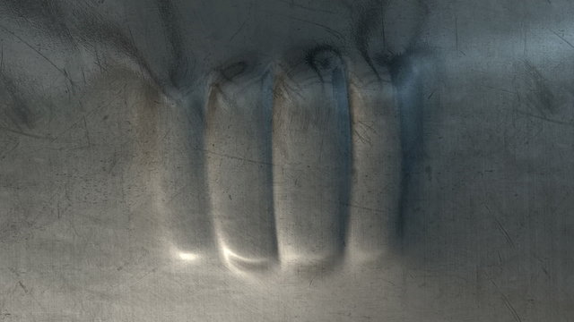 A flat sheet of metal being punched at twice on the opposite site resulting in a fist shaped dent developing as a result of an angry outburst