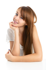 Portrait of a beautiful young smiling girl on a light background.