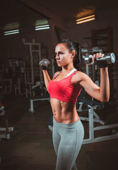 fitness woman doing exercises with dumbbell in the gym