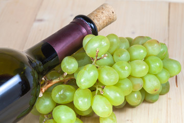 green grape and wine bottle