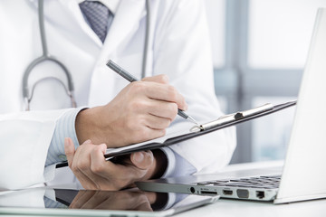Close-up of a medical worker with laptop