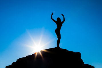 Silhouette of the sports women against the sky