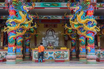 Old man praying at chinese shrine